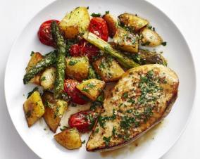 Roast chicken thighs with garlic butter potatoes and tomato salad