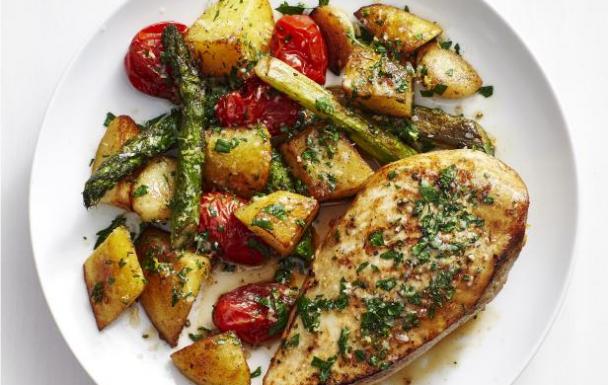 Roast chicken thighs with garlic butter potatoes and tomato salad